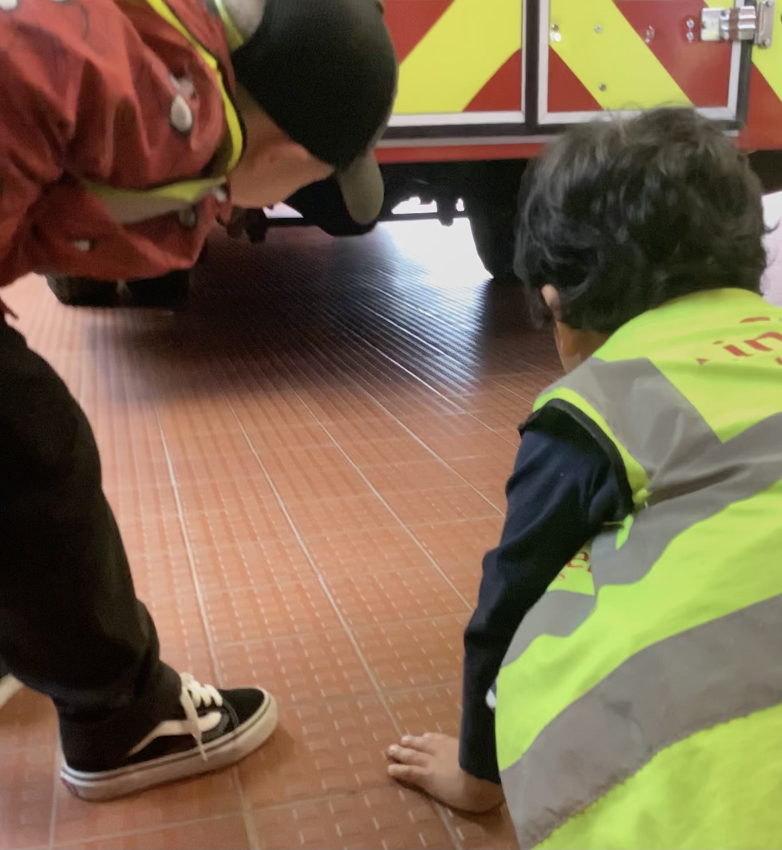 Reggie and Arthur were wondering what was under the fire engine. 