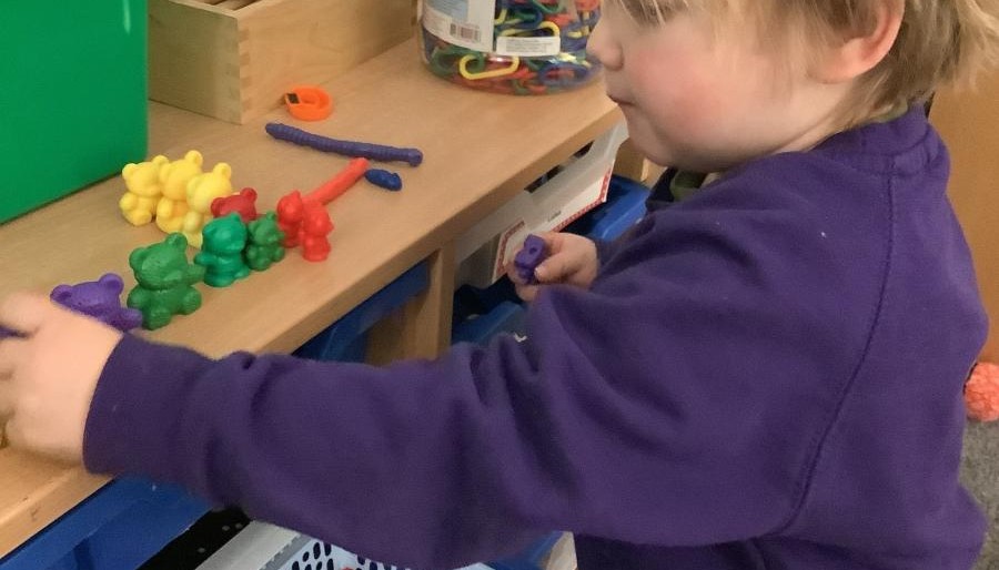 Child playing with small plastic bears