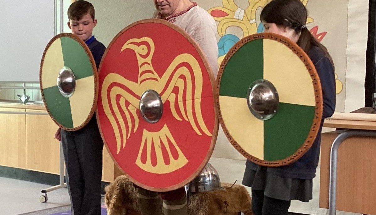Children holding shield