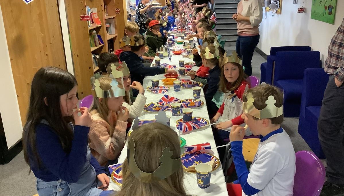 Children sat at long table 