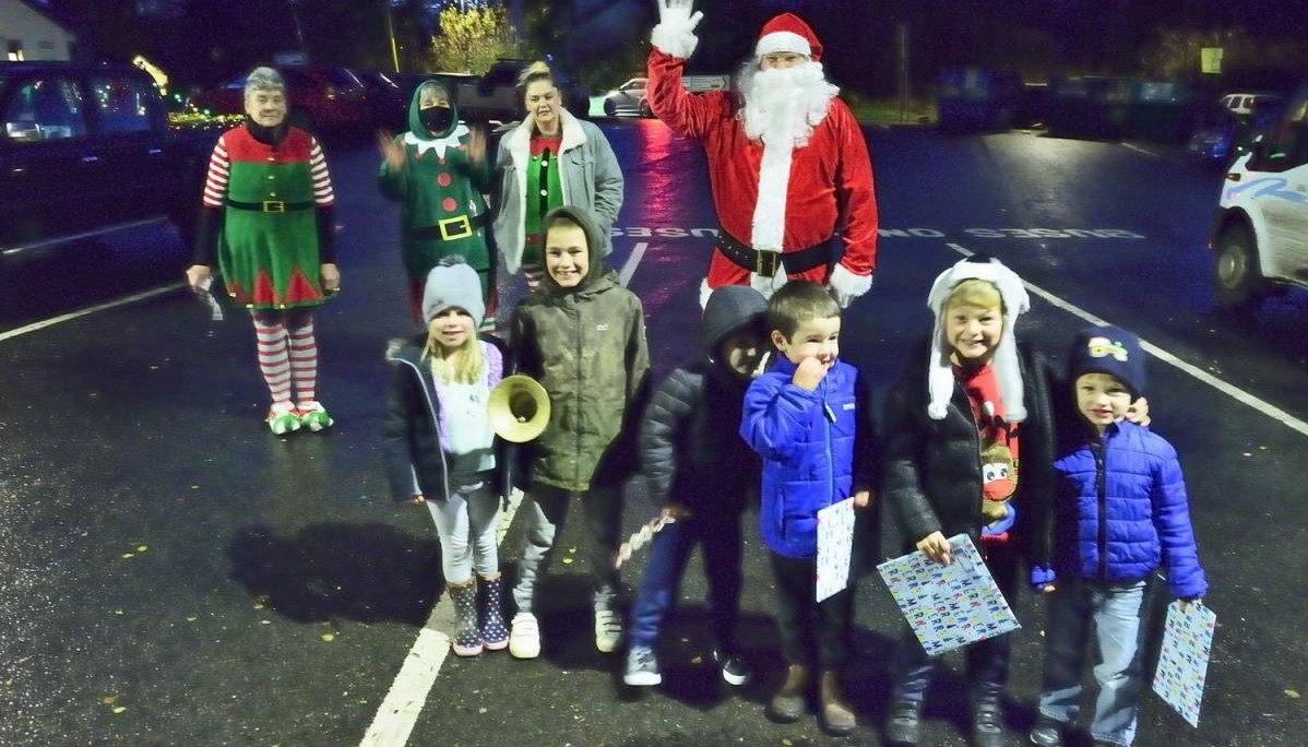 children stood with father christmas 