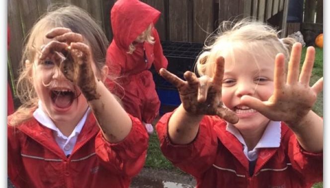 Children showing the camera their hands