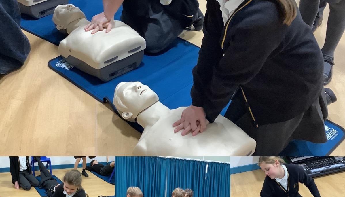 Children practising CPR on dummy 