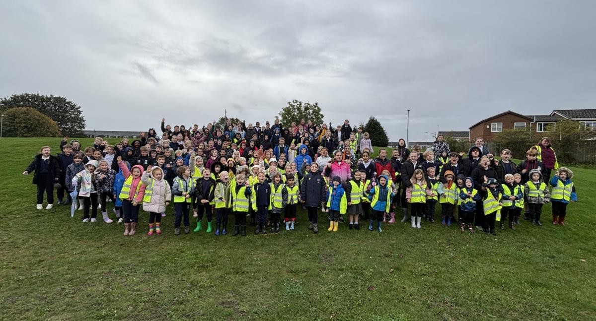 The drizzle didn't stop us enjoying ourselves - this is everyone from Reception to Year 6 on Eastfield playing fields.