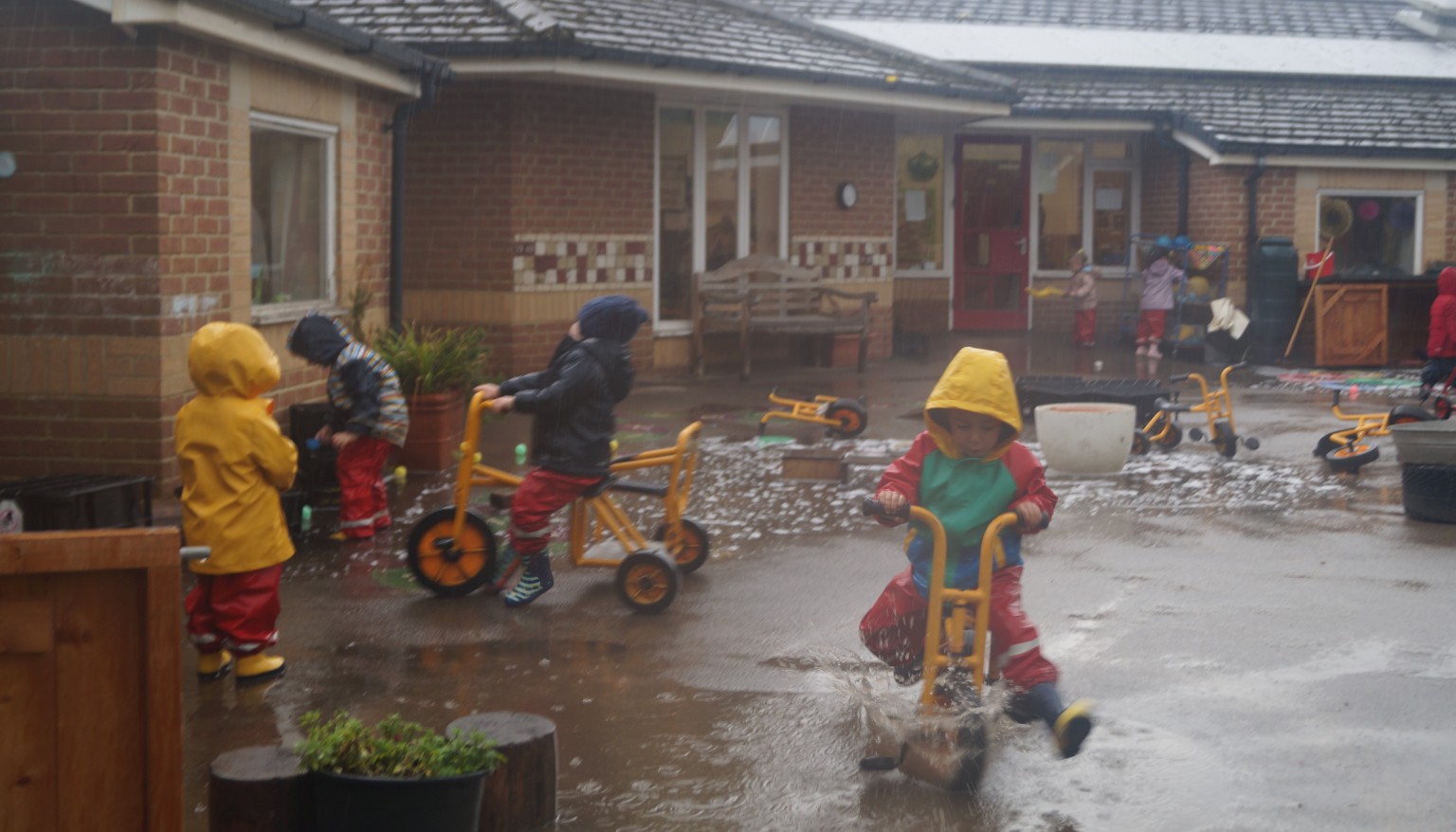 Children playing in the rain
