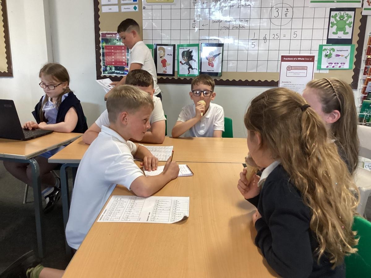 Last year's Year 3 practising their French skills, ordering ice creams in our 'pop up shop'!