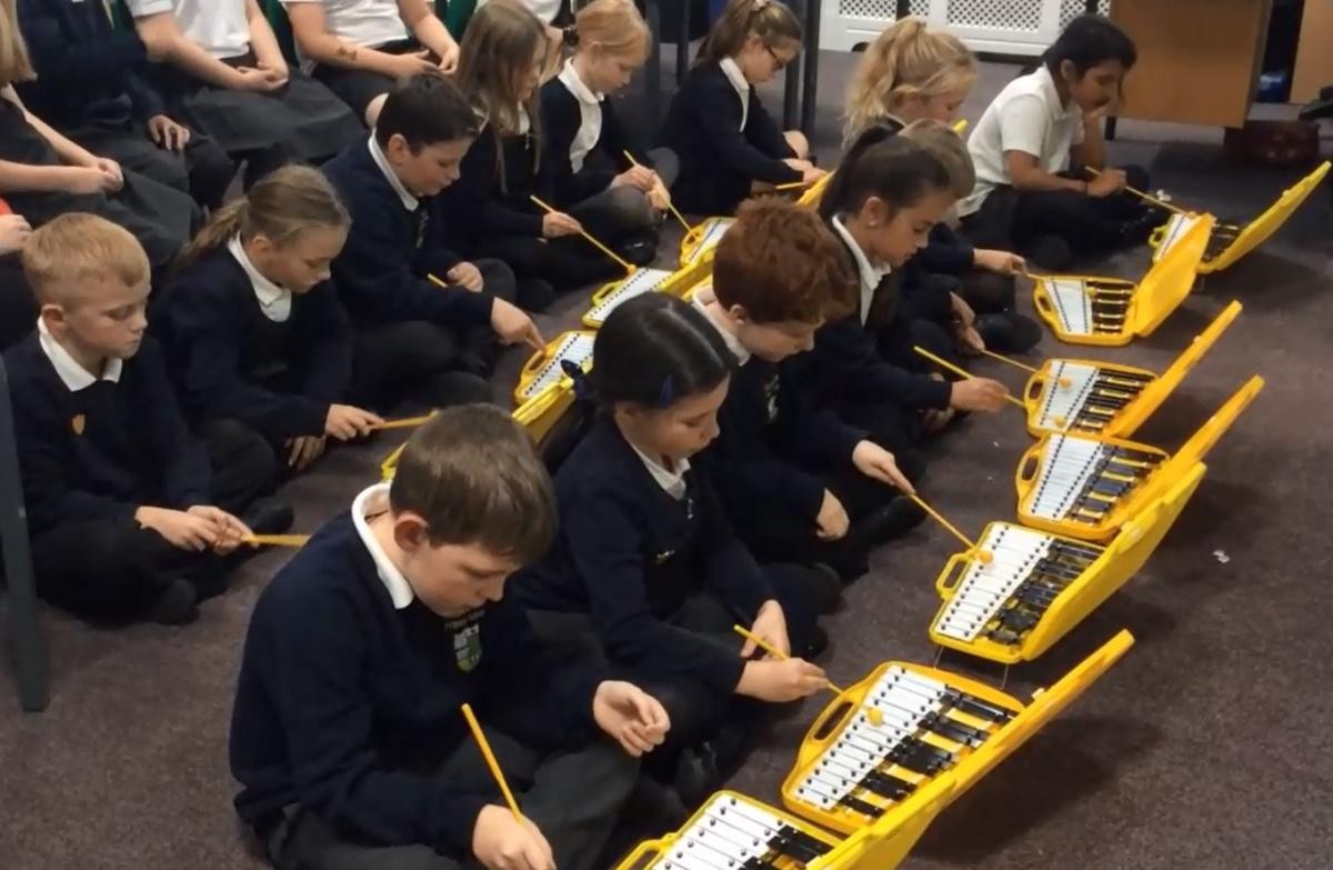 Playing glockenspiels as part of a class performance