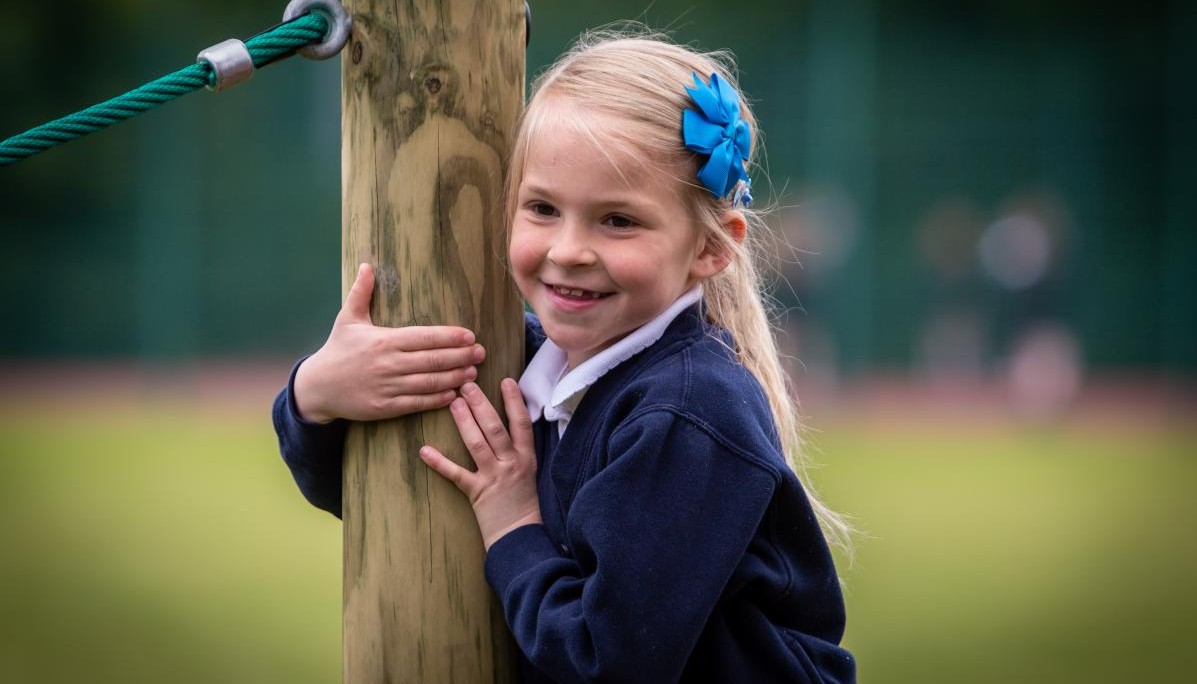 Child holding onto trim trail 