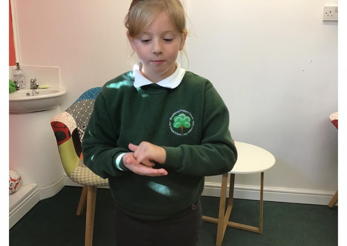 Re-telling a story to the Headteacher using Sign Language.
