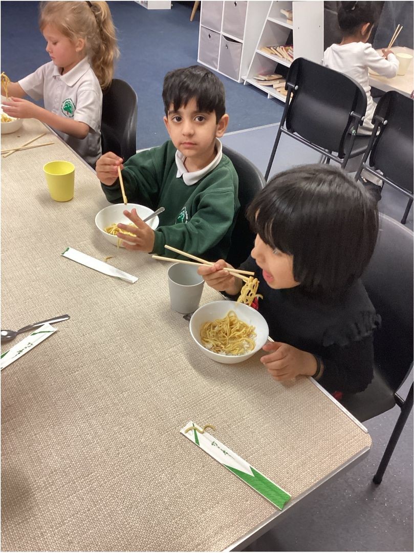 Look at us eating our noodles with chopsticks