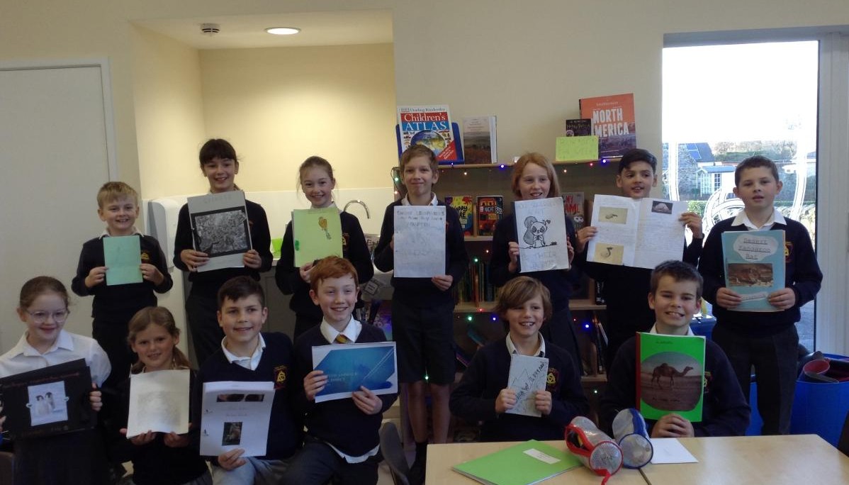 Group of children holding up pictures