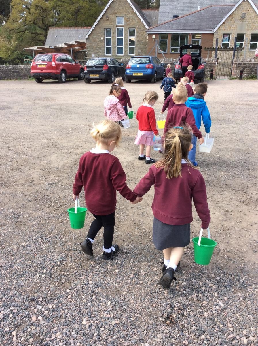 Walking back to school with our buckets of water.