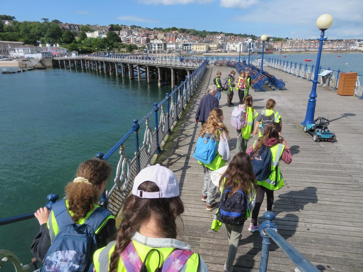 Pupils walking along the bay