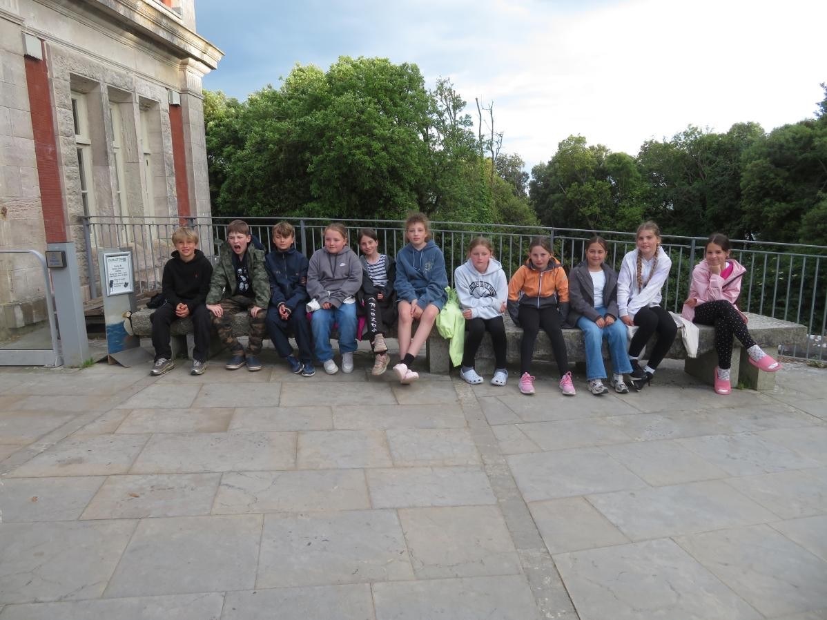 Row of pupils sitting outside