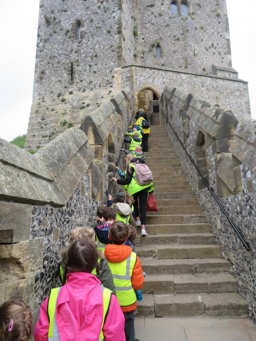Children climbing castle staircase