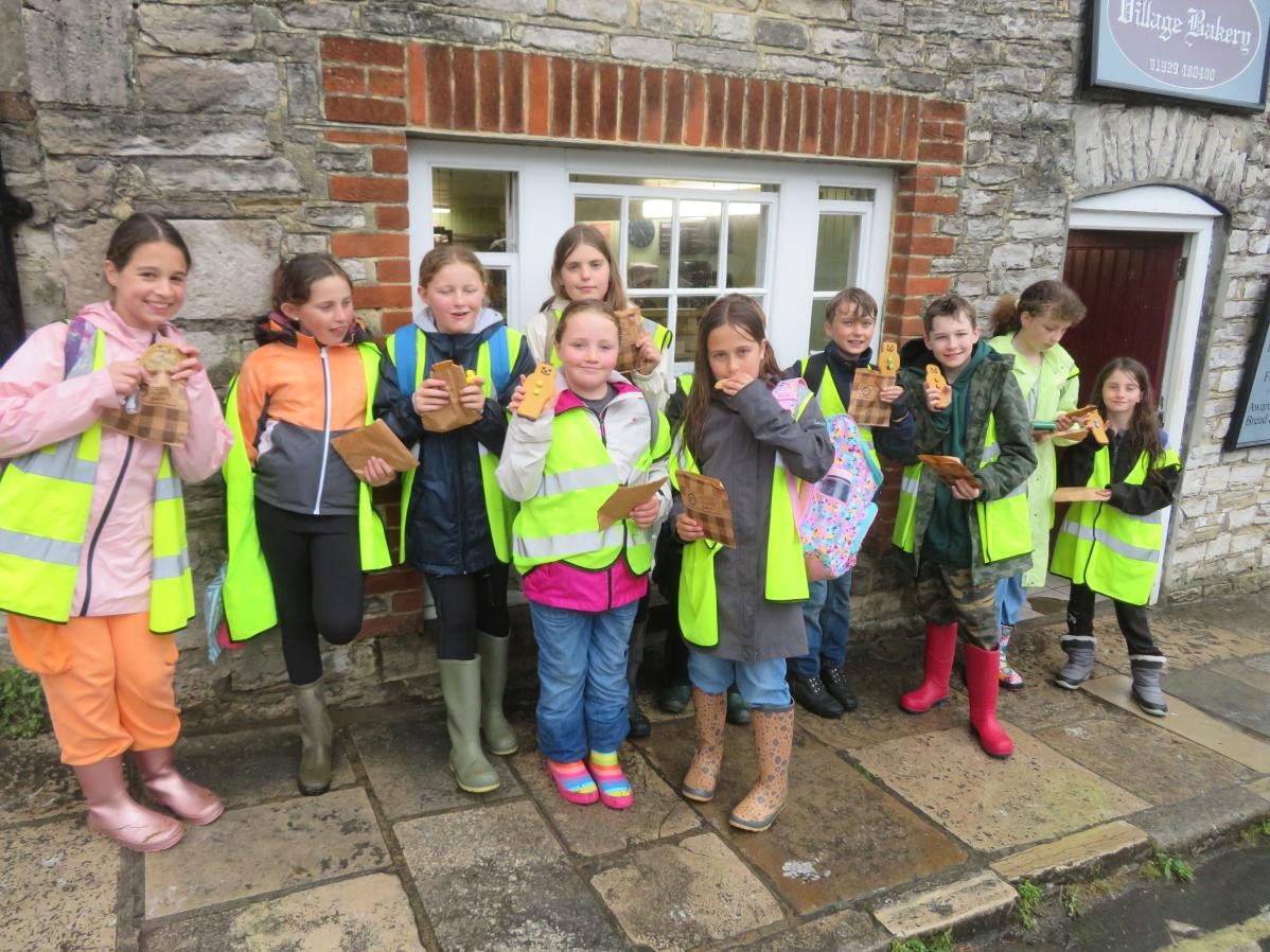 Group of smiling pupils with thumbs up