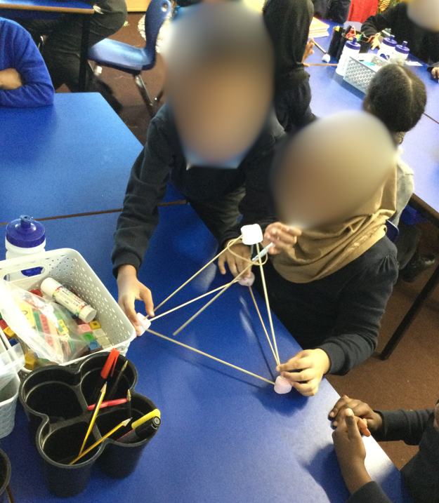 Children planning their catapult making using pasta and marshmallows