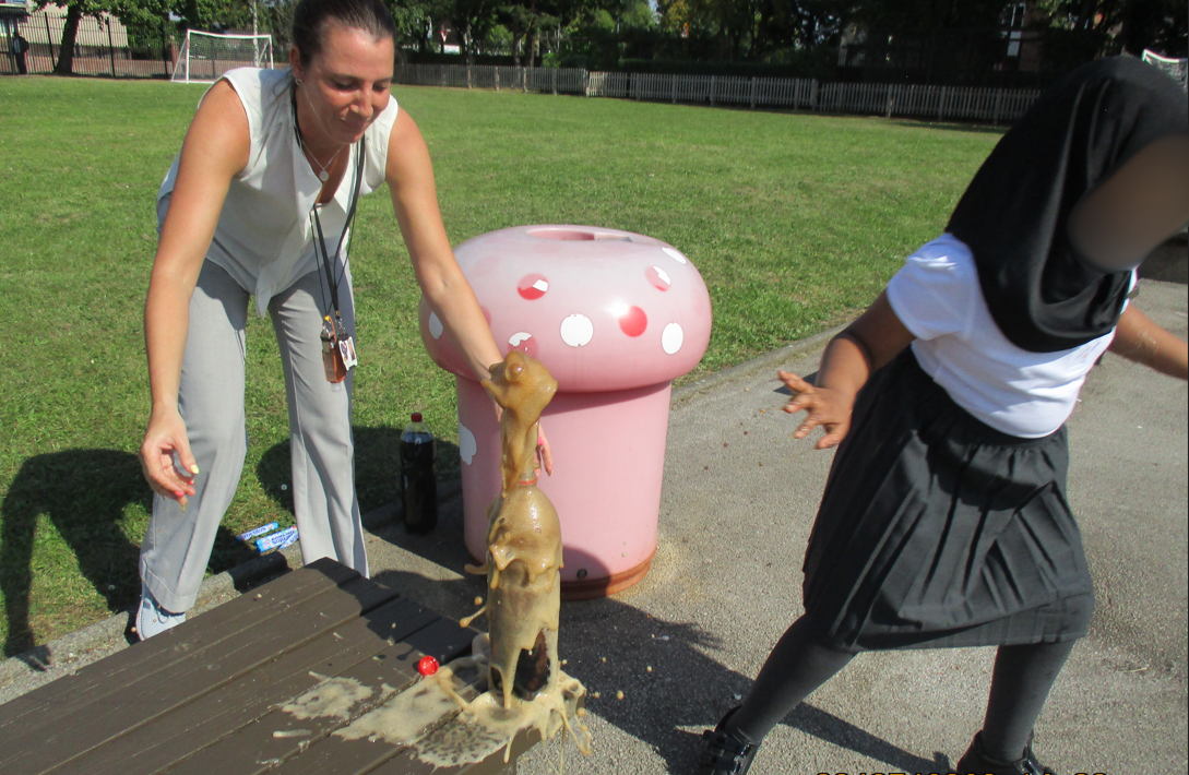 Children seeing the chemical reaction when mentos are added to coke.