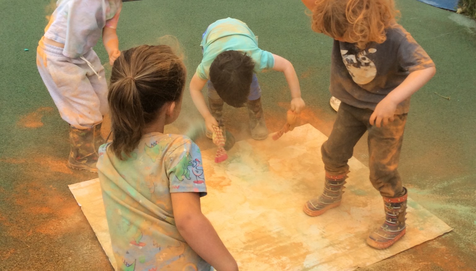 Children jumping in coloured ppowder