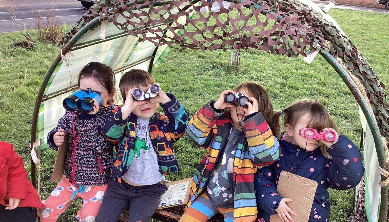 Children looking through binnoculars
