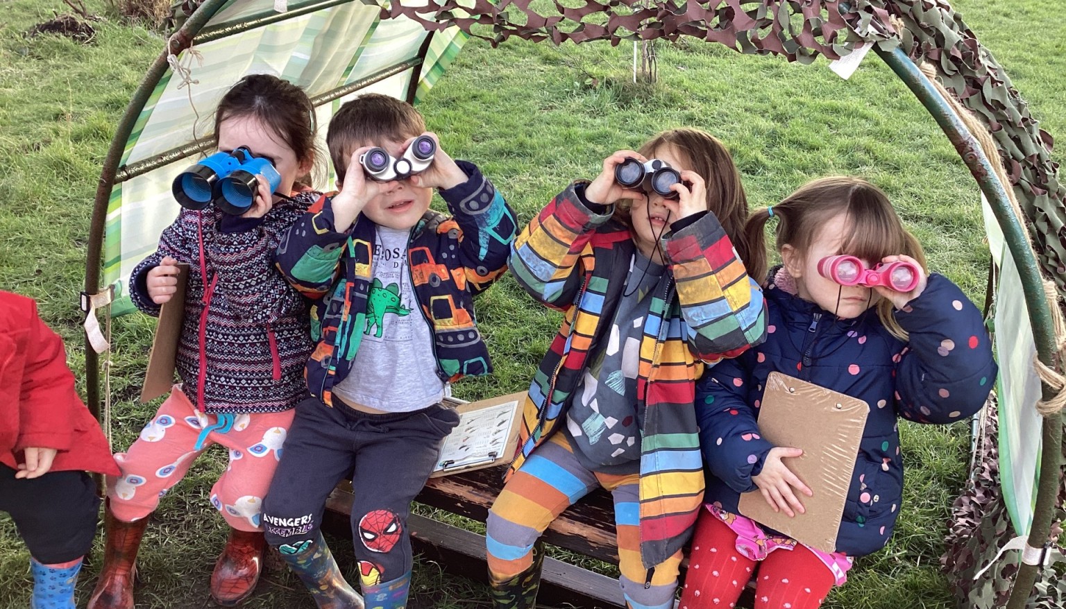 children looking through binocculars