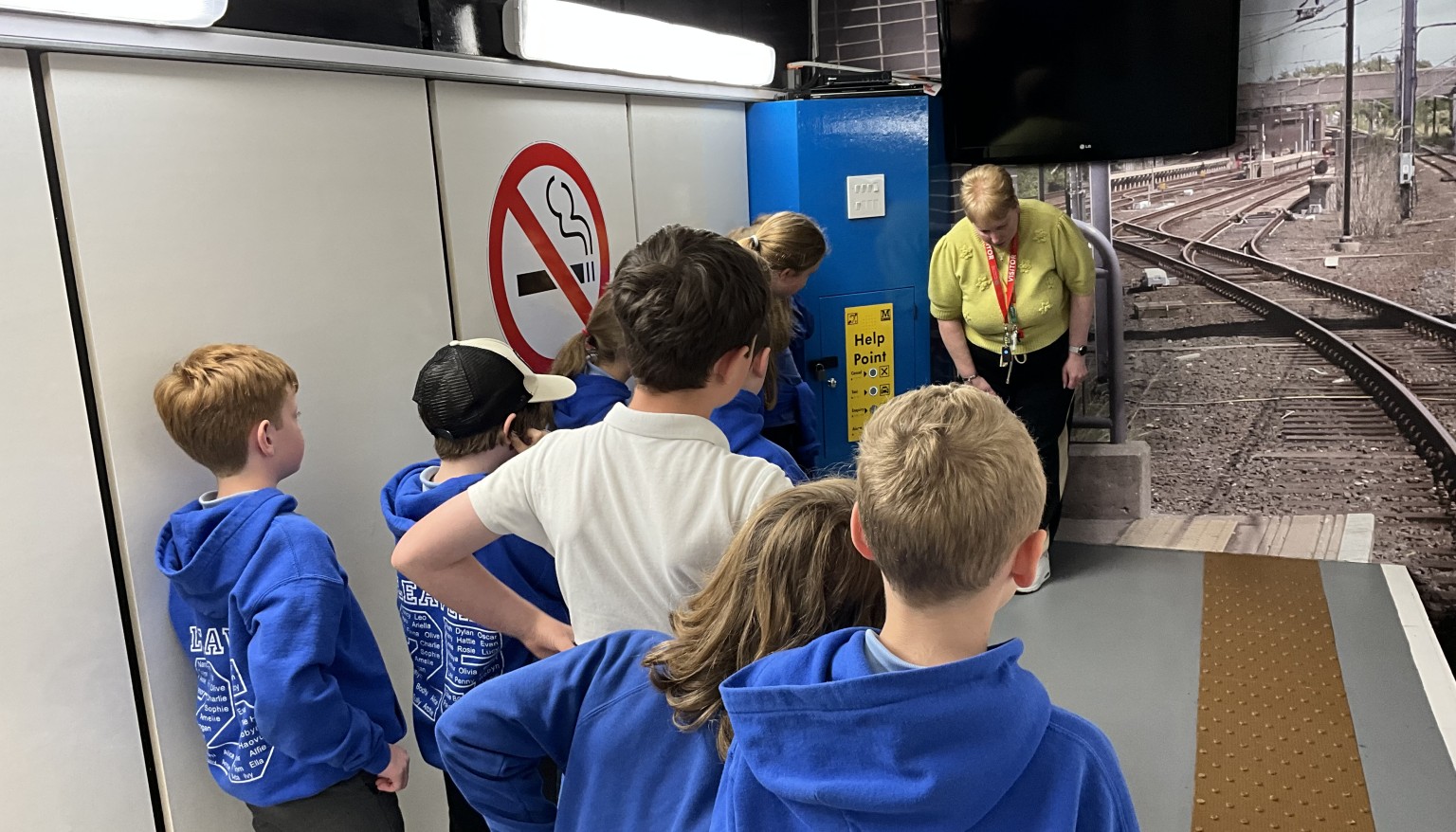 Children stood listening to adult