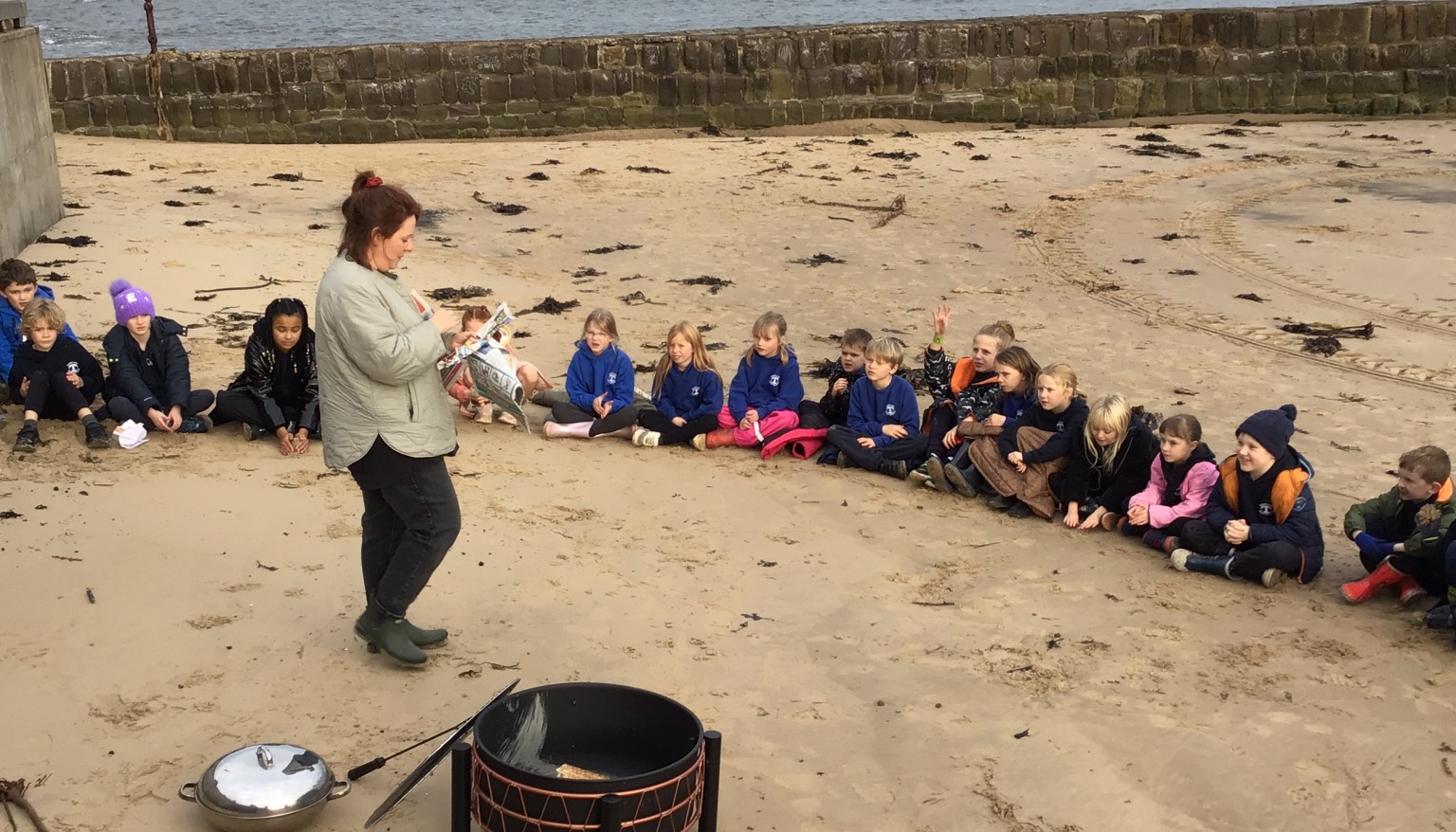 Children aruound a beach camp fire