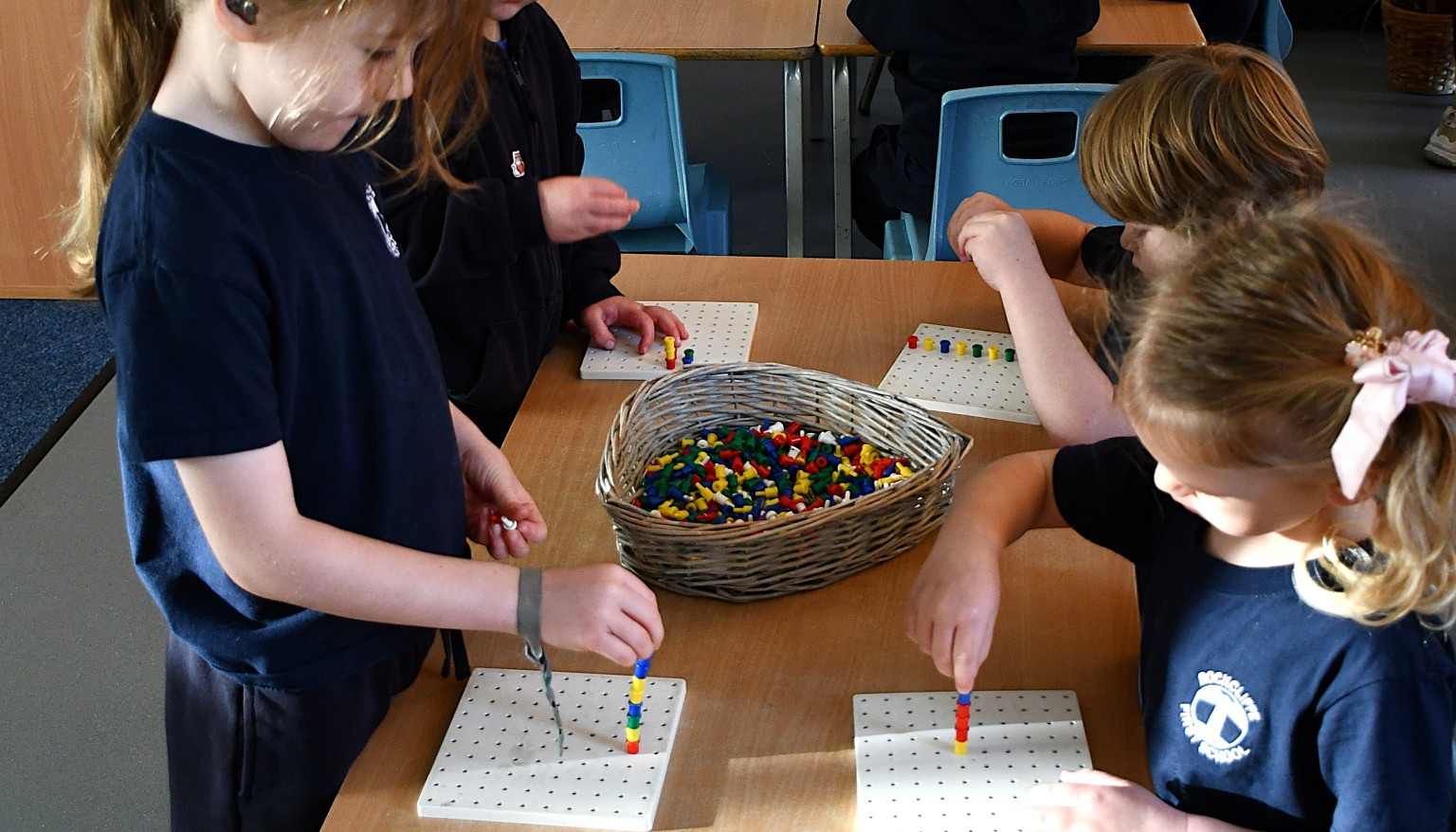 children using peg boards