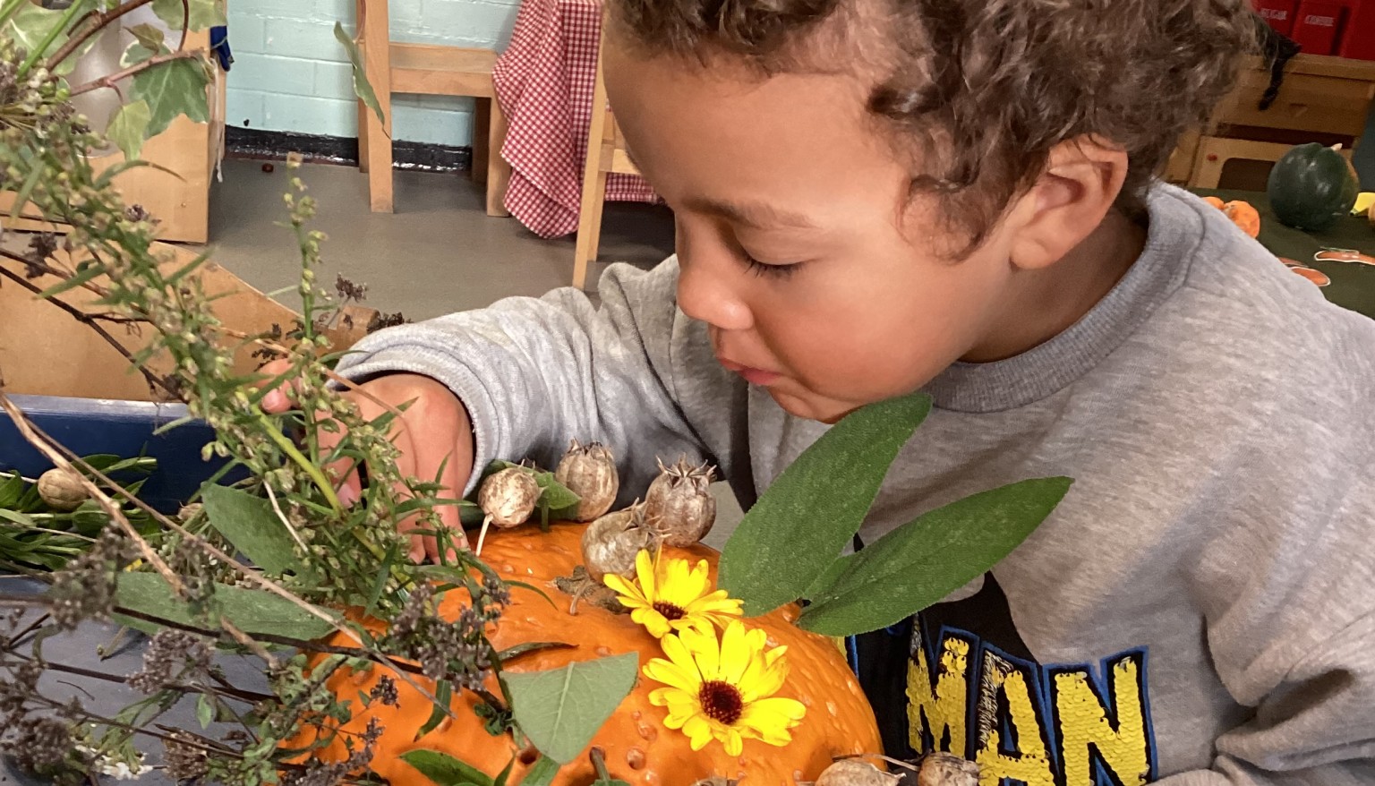 Boy looking at pumpkin
