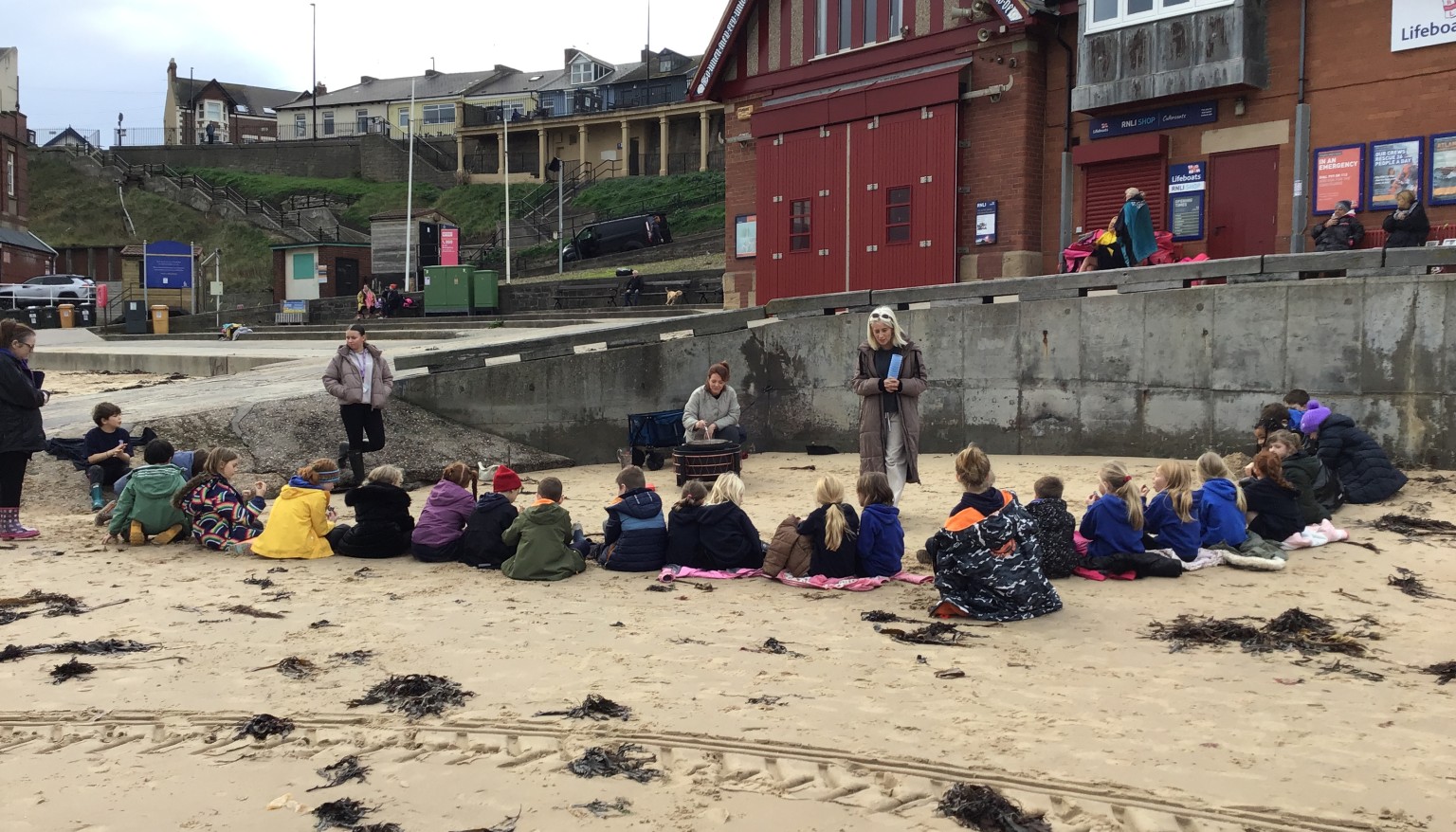 Children sitting on the beach