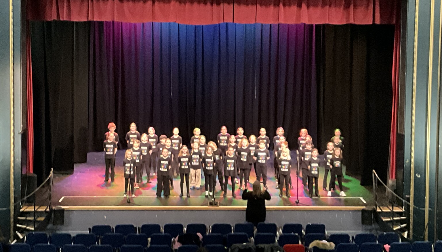 children on stage singing