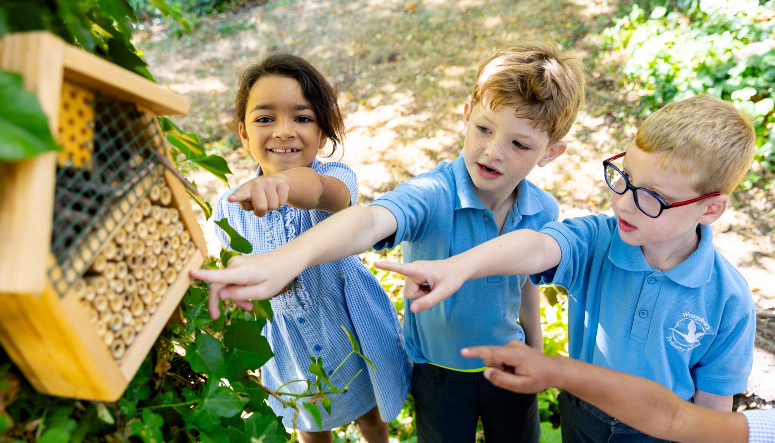 Children pointing at bug house