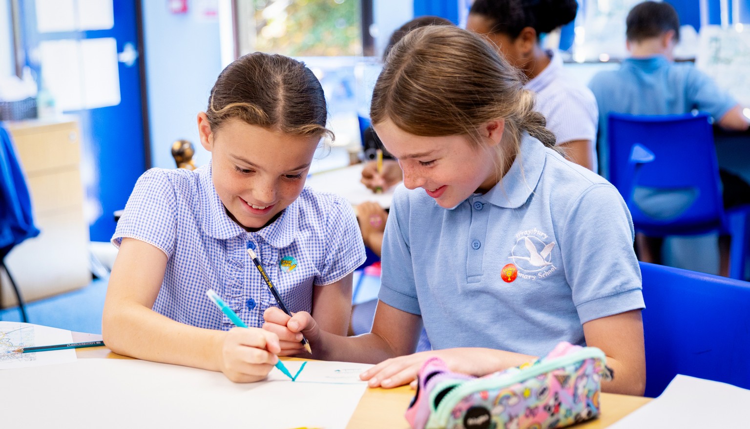 Two children writing 