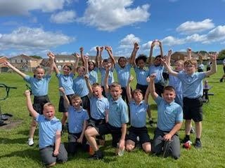 Children on the sunny field cheering