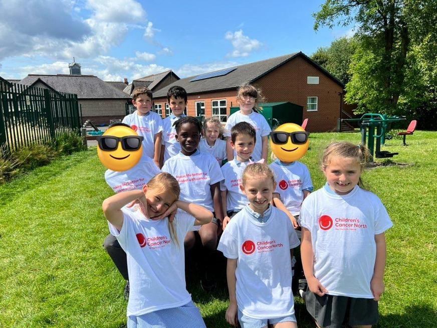 Group of smiling children wearing Children's Cancer North t'shirts