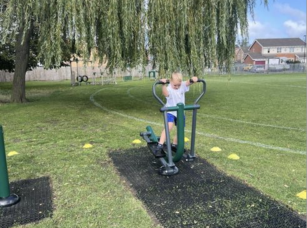 Pupil on the outdoor gym equipment
