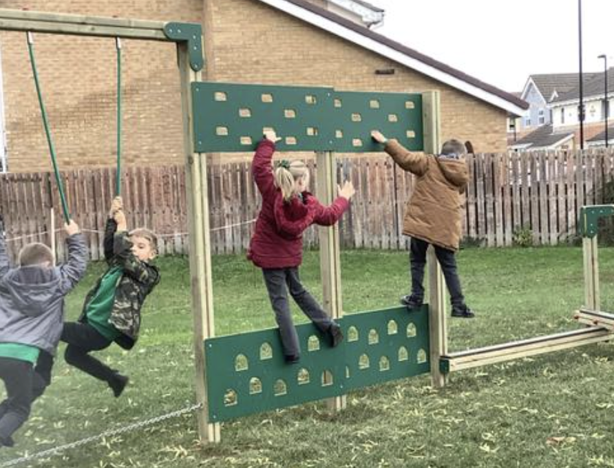 Pupils climbing on their play trail