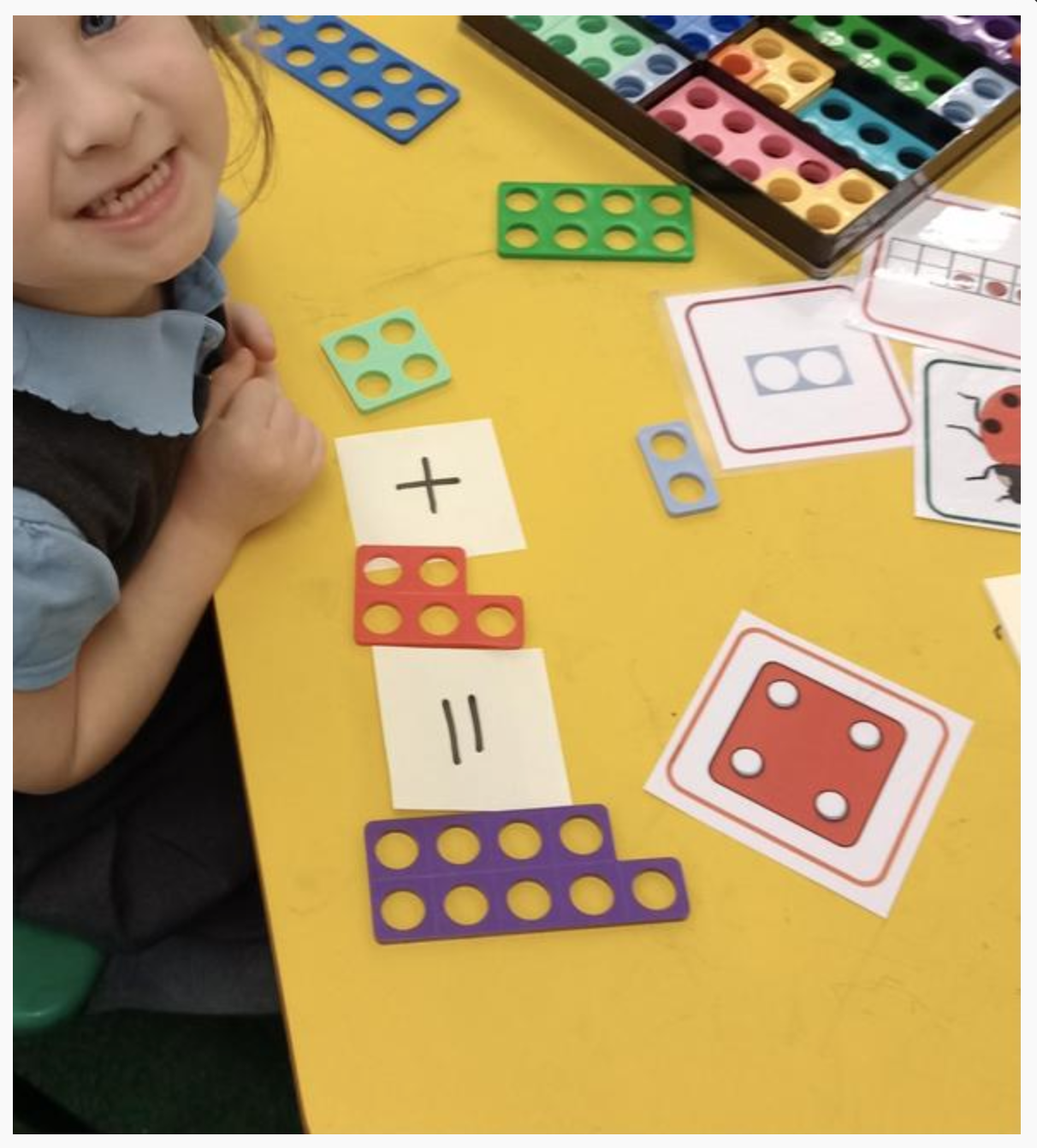Children in Reception independently choosing equipment to show understanding of addition