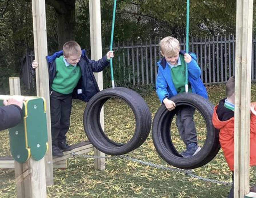 Pupils climbing on their play trail