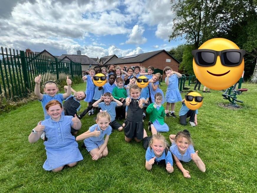 Group of smiling kids with thumbs up 