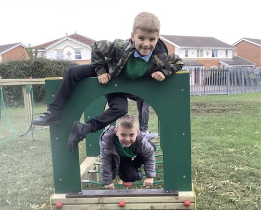 Pupils climbing on their play trail