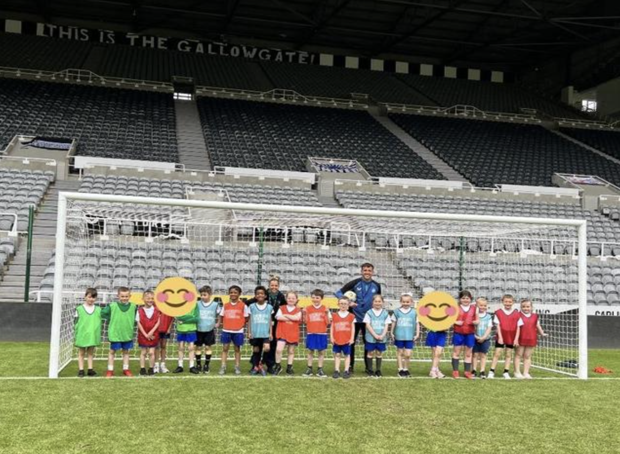 Smiling pupils at the Gallowgate goal, St James' Park