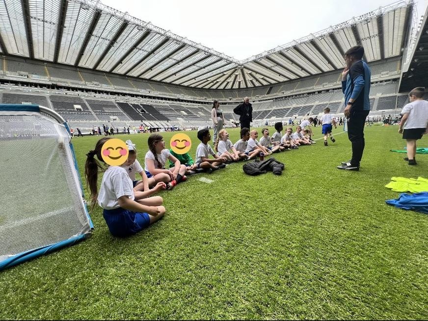 Pupils, on the pitch, at St James' Park