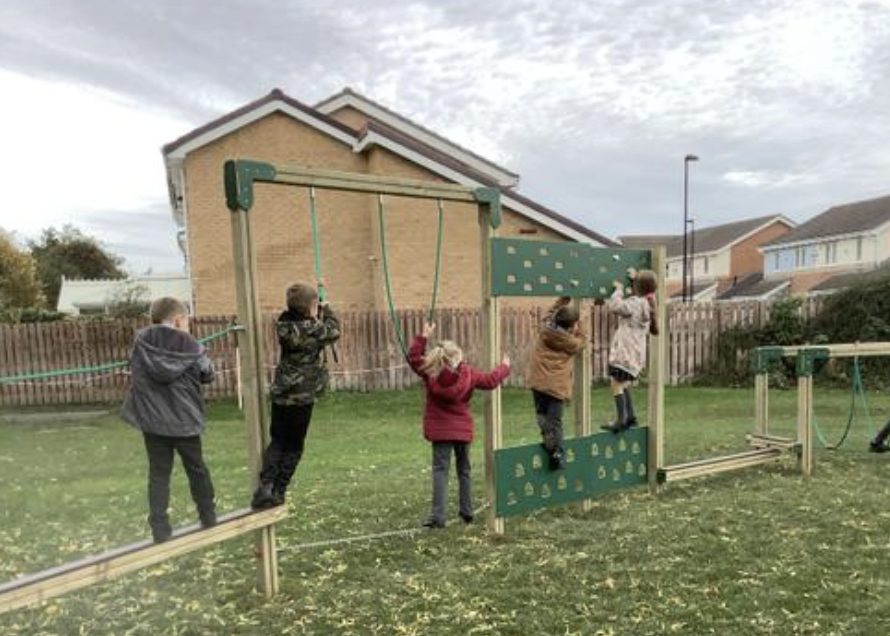 Pupils climbing on their play trail
