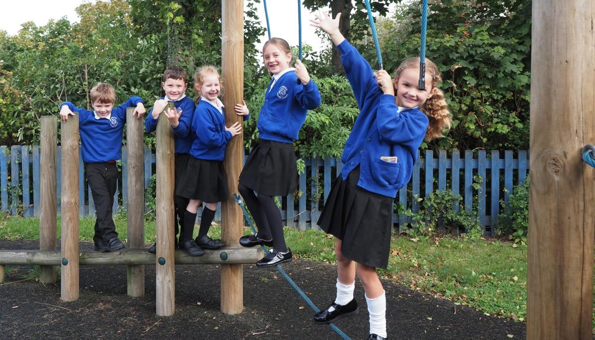 Pupils climbing on outdoor equipment