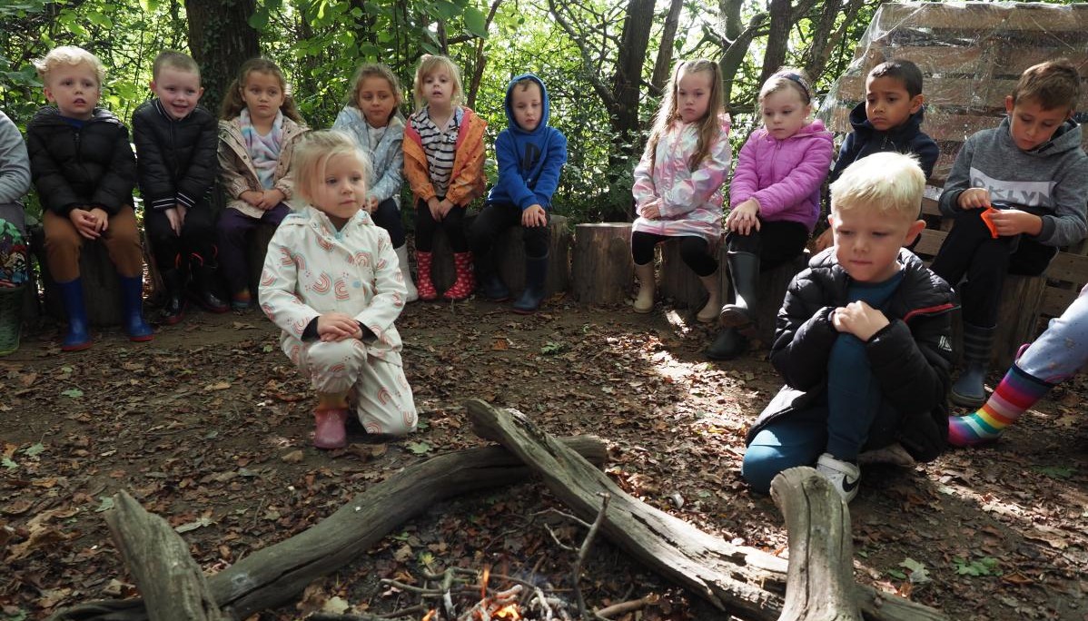 Pupils around camp fire