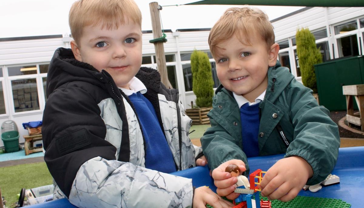 Pupils building with lego outside
