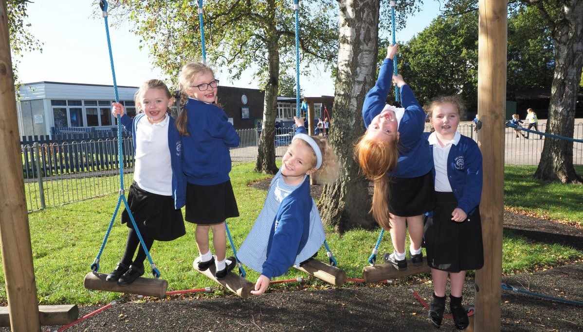 Pupils outside on play equipment