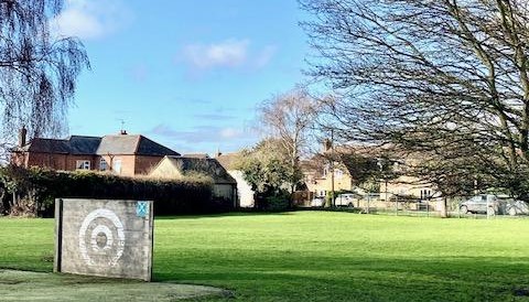 School Grounds Blue sky and green field