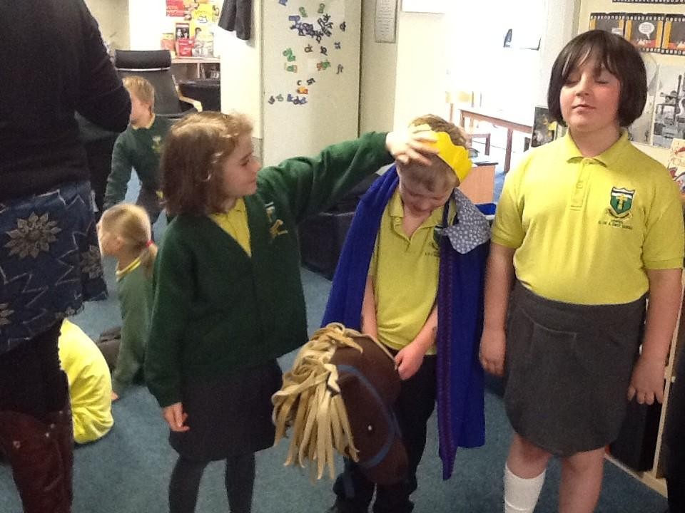 With great excitement, shouting and waving of palm leaves.